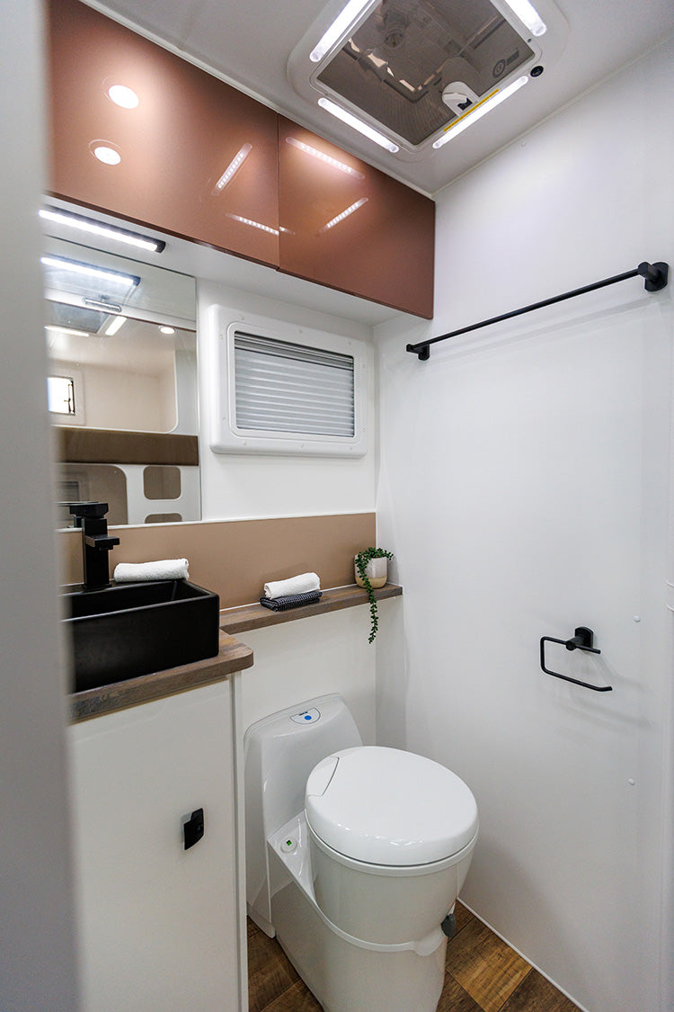 ProRV Falcon Angle Kitchen Cravan Interior Toilet Including Tap, Sink, Mirror, Drawers, and Toilet.
