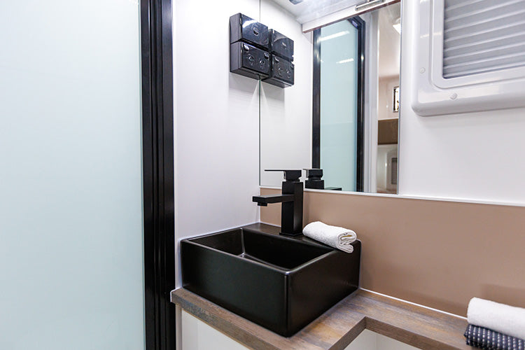 ProRV Falcon Angle Kitchen Cravan Interior Toilet Including Tap, Sink, and Mirror Zoomed In.