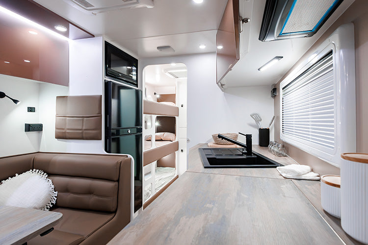 ProRV Falcon Angle Kitchen Caravan Interior Living Area Angled View Including Fridge, Microwave and Bunks.