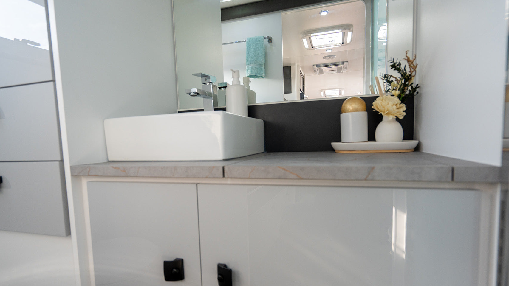 ProRV Family Hawk Cravan Interior Toilet Including Tap, Sink, and Cupboards.