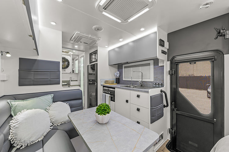 ProRV Family Jaguar Caravan Interior Living Area Full View Facing Toilet Angled Towards Kitchen Showing Entrance Door.