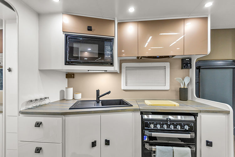 ProRV Kookaburra Aluminium Frame Caravan Interior Kitchen Including Tap, Sink, Covered Cooktop, Cupboards, Drawers, Microwave and Oven Full View.