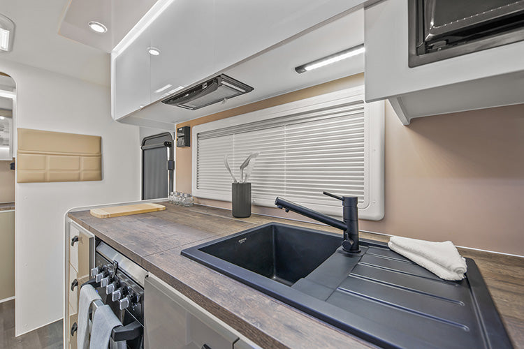 ProRV Panda Aluminium Frame Caravan Interior Kitchen Including Tap, Sink, Covered Cooktop, Cupboards, Drawers, and Oven.