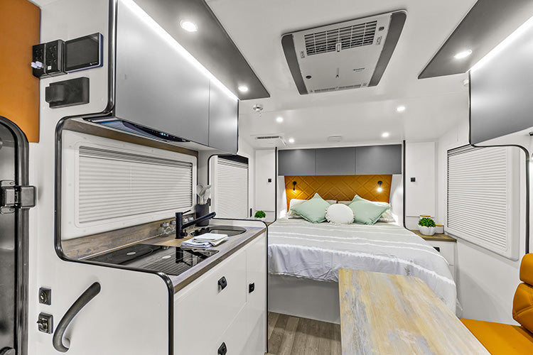 ProRV Puma Aluminium Frame Caravan Interior Living Area Full View Facing Bed Zoomed In Angled Towards Kitchen.